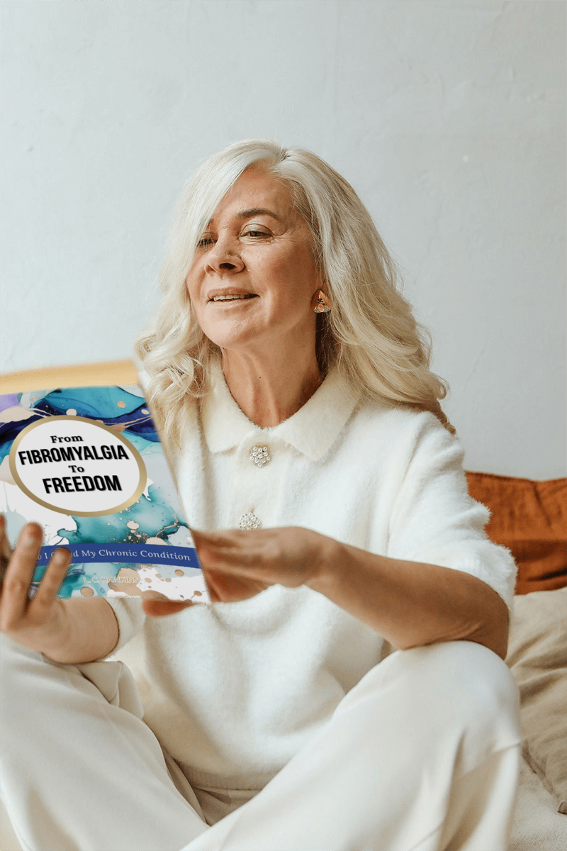 Lindsey Hawkins holding her book, From Fibromyalgia to Freedom